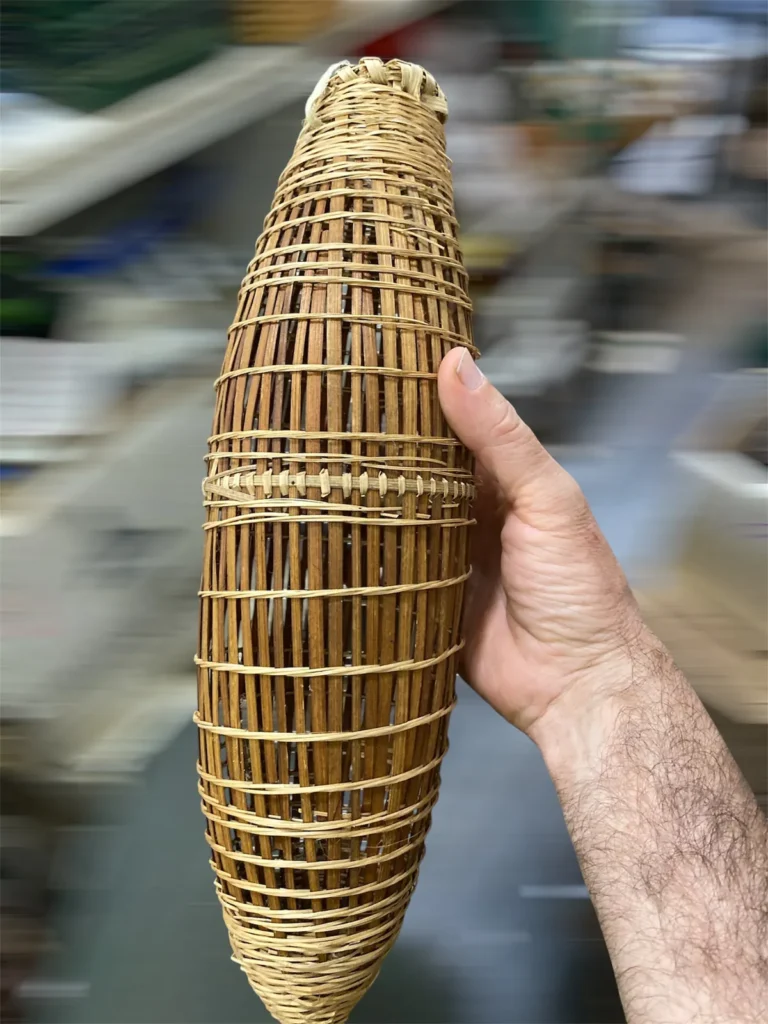 Close-up of a handwoven bamboo đó fish-trap basket held in hand at DH Garden Centre in Vancouver
