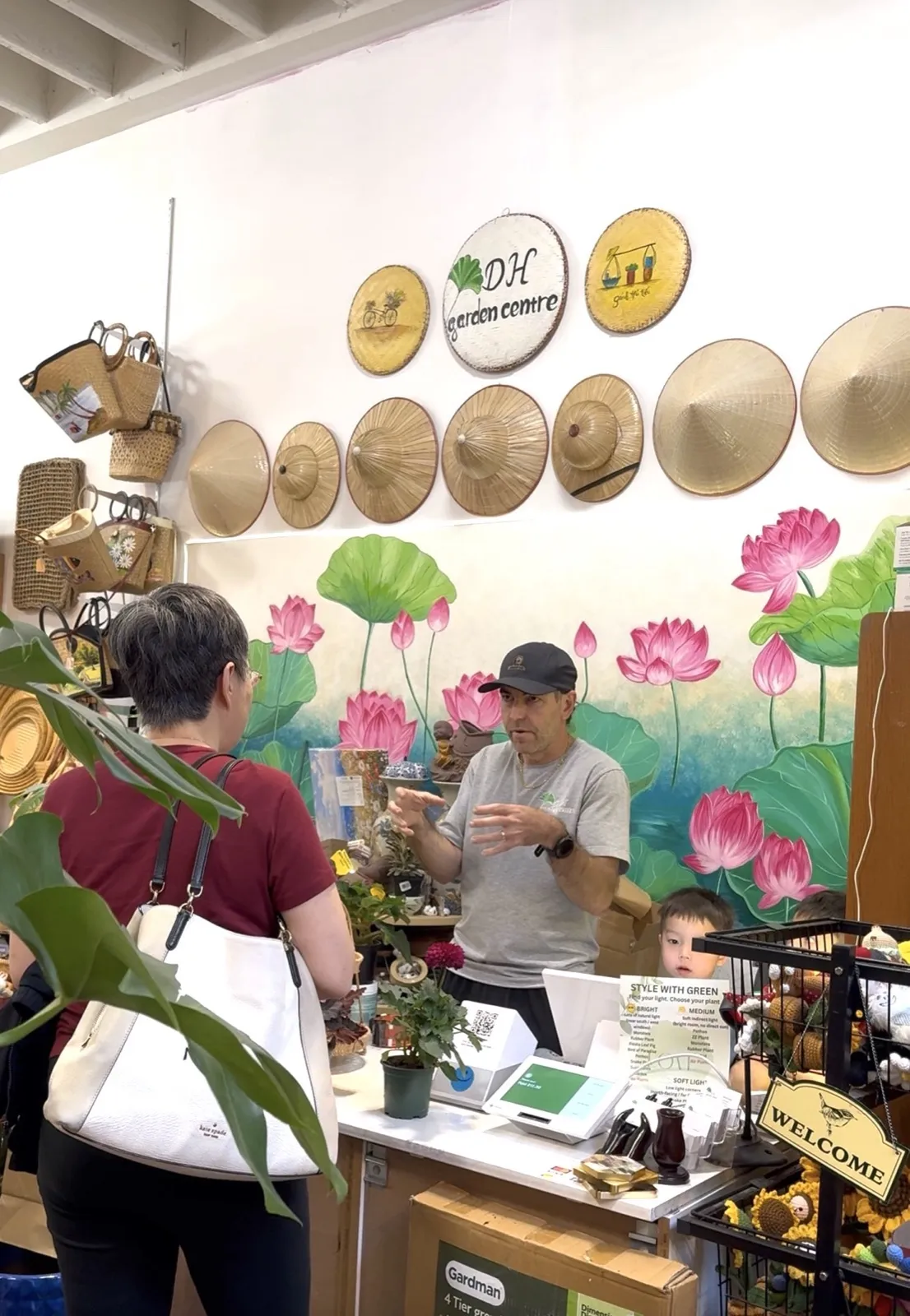 Darrell Smith helping a customer at the counter of DH Garden Centre
